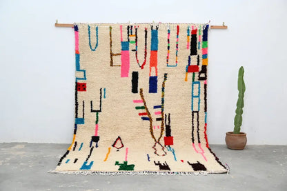 Beige moroccan azilal rug with vibrant geometric patterns bedroom decor