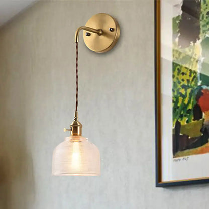 Industrial brass sconce with textured glass dome – bedroom light