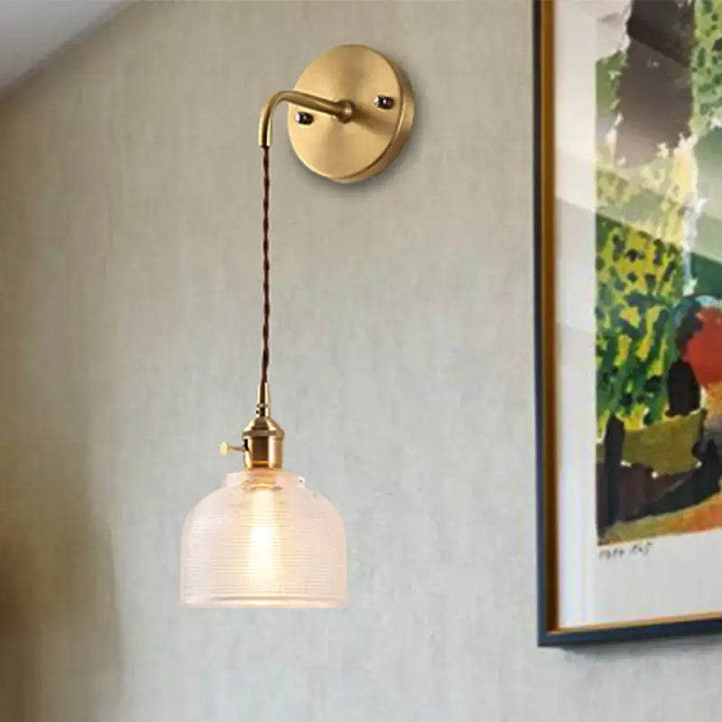 Industrial brass sconce with textured glass dome – bedroom light