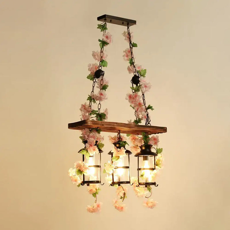 Rustic industrial cage island light with pink flowers dining room