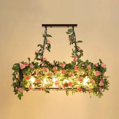 Rustic industrial cage island light with pink flowers dining room