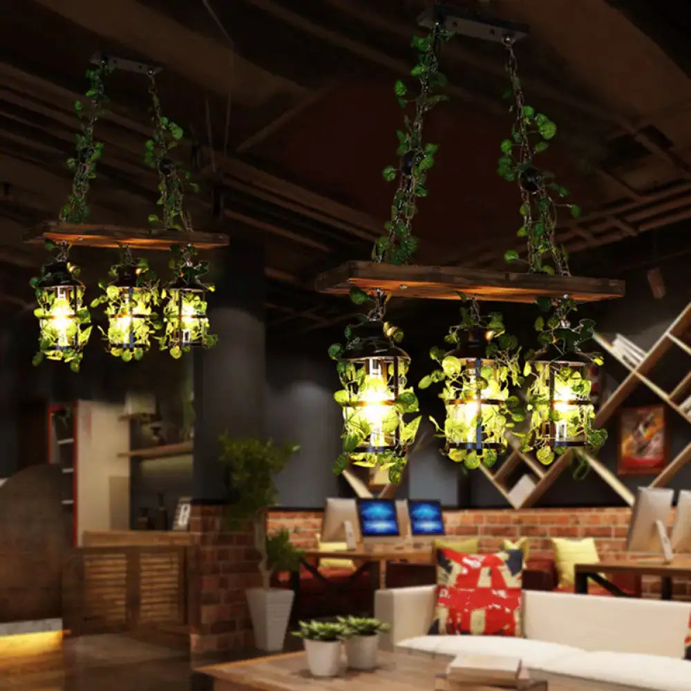 Industrial wood and clear glass restaurant island light with plants