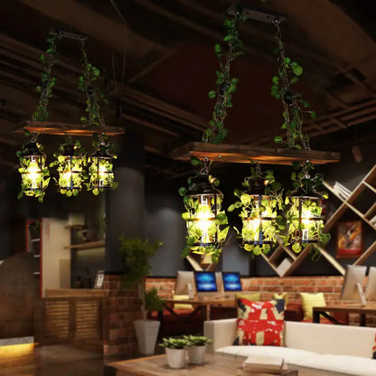 Industrial wood and clear glass restaurant island light with plants