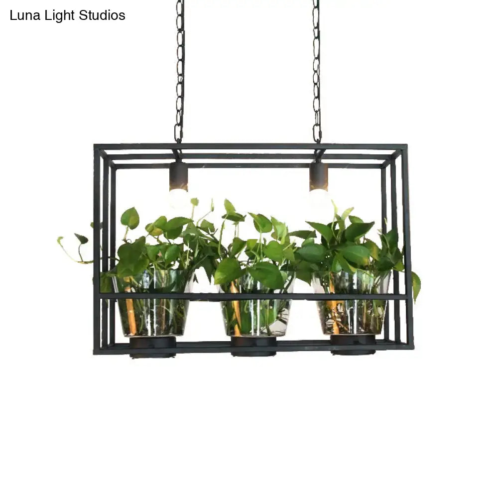 Industrial black iron island light with glass plant pot dining room