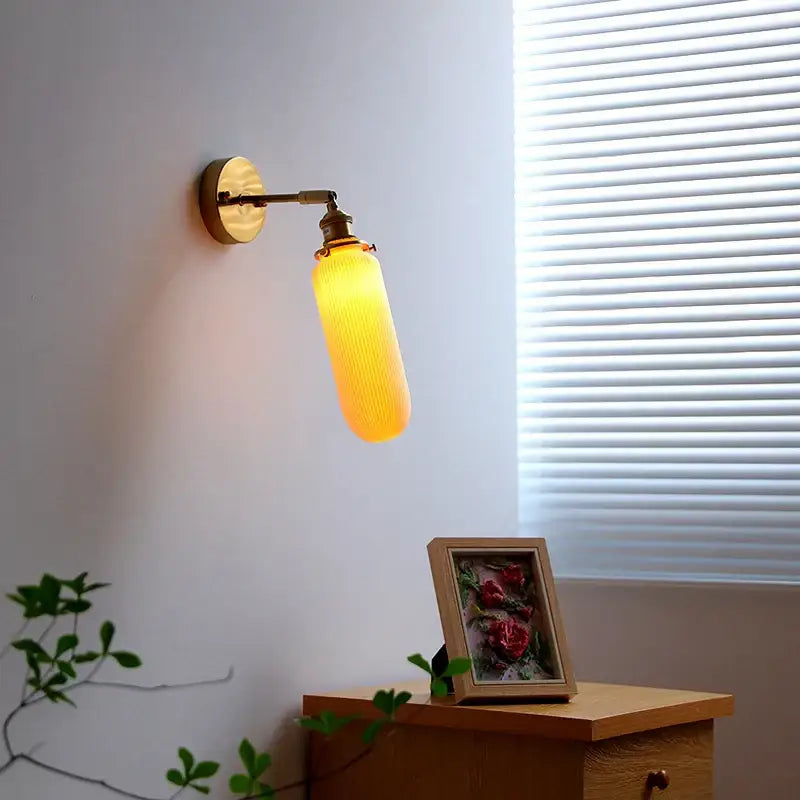 Ribbed white glass and brass ceramic wall sconce for bedroom lighting