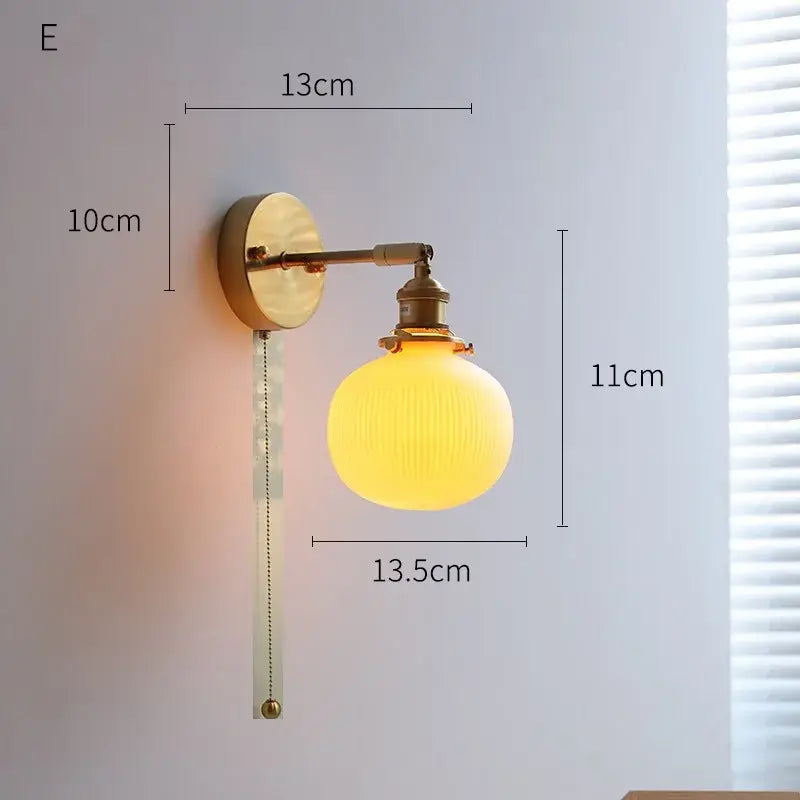 Ribbed white glass and brass ceramic wall sconce for bedroom lighting