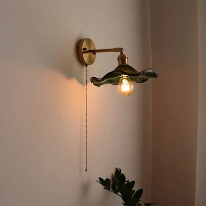 Green ribbed glass wall sconce with pull chain switch for bedroom