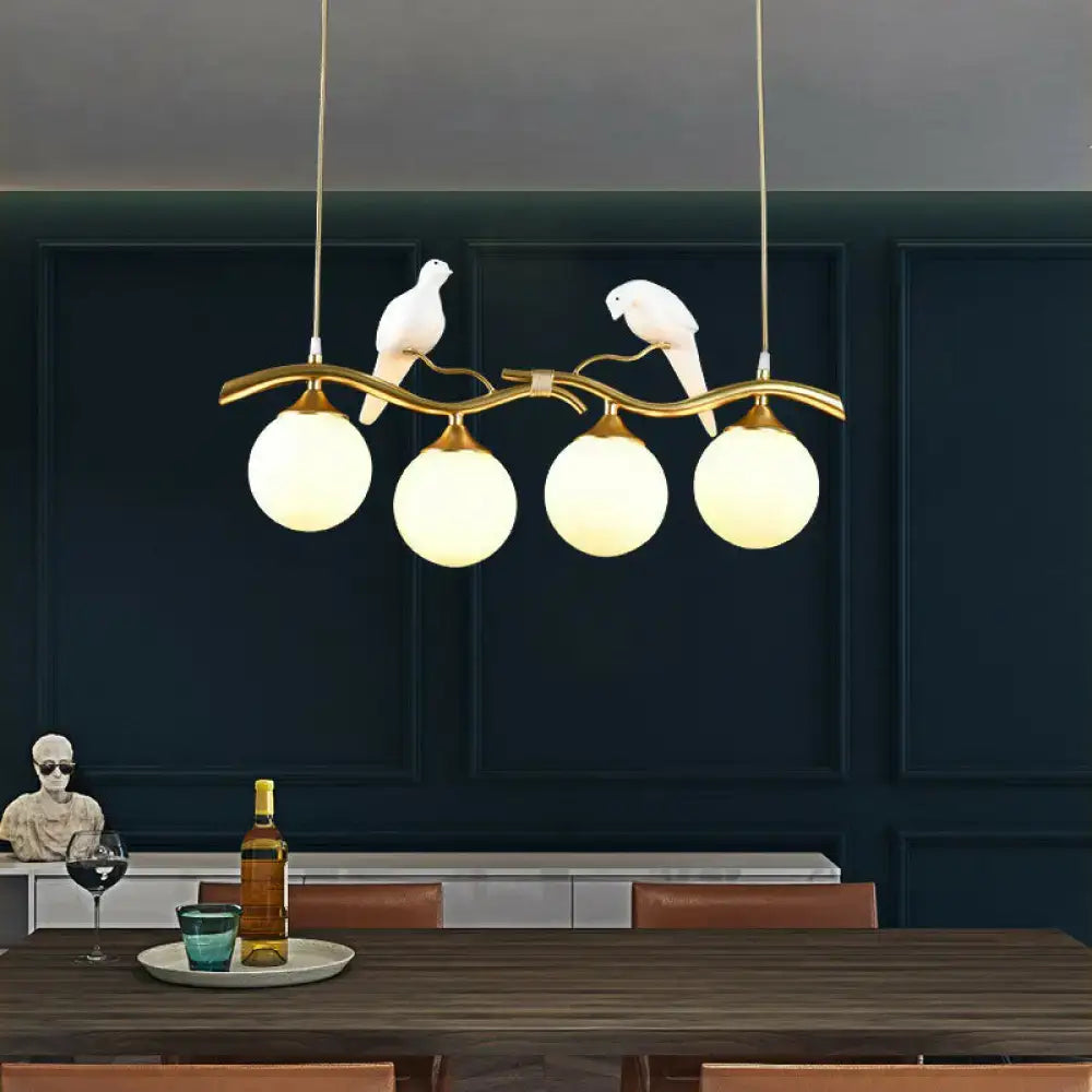 Modern bird branch island pendant light – dining room amber glass
