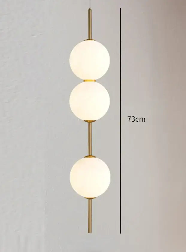Modern gold glass pendant lighting – dining room spherical bulbs