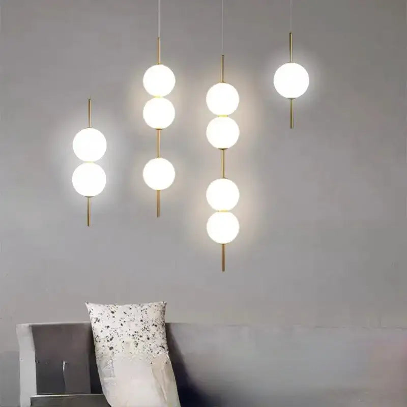 Modern gold glass pendant lighting – dining room spherical bulbs