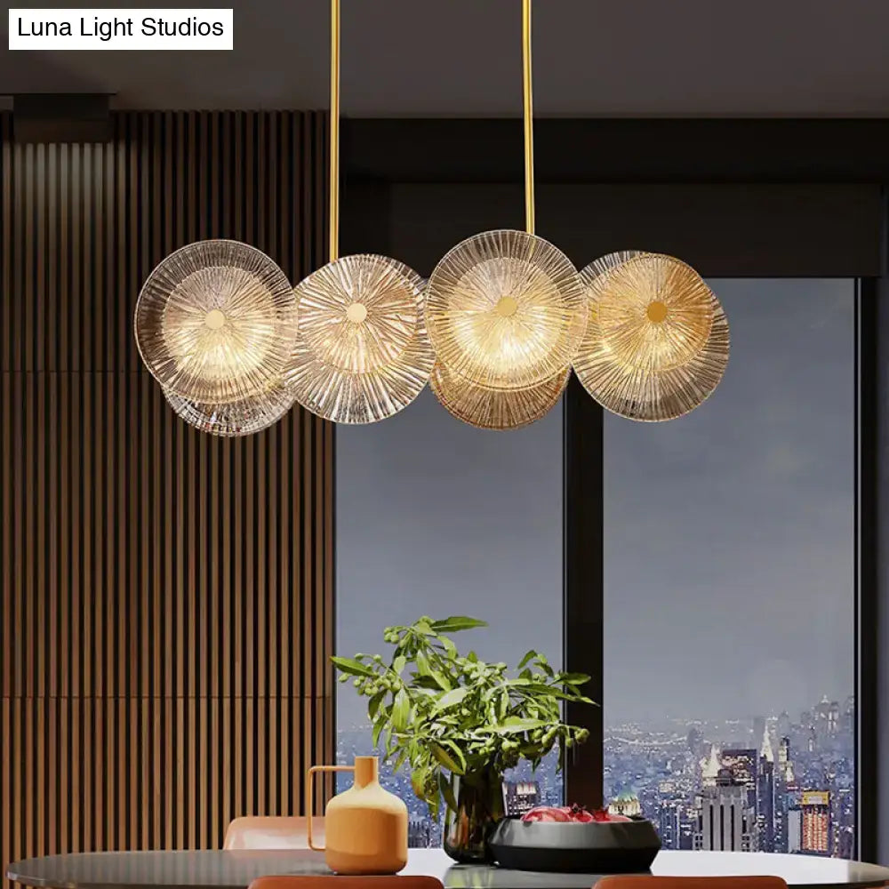 Modern gold finish pendant light with prismatic glass shade dining room
