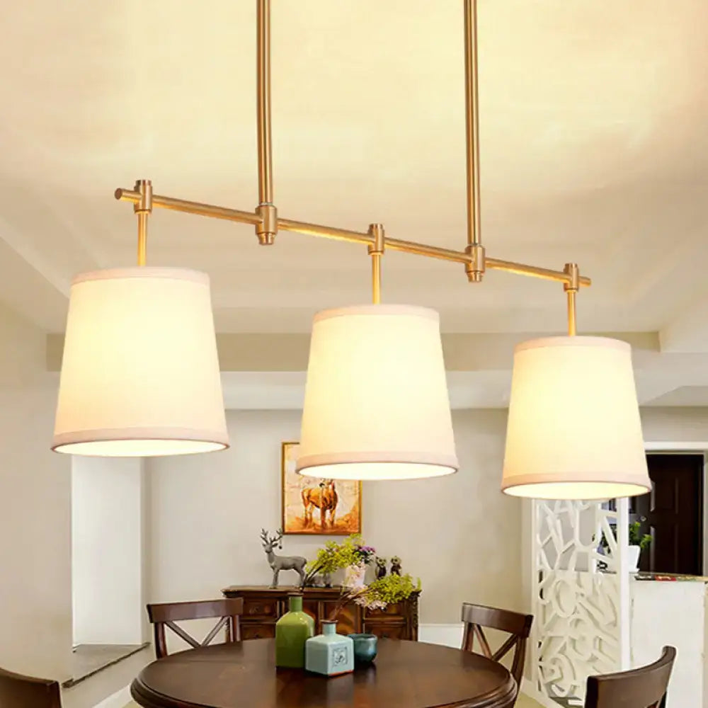 Modern gold island chandelier with fabric empire shade dining room