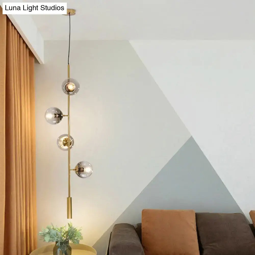 Modern gold linear chandelier with gray glass shades dining room