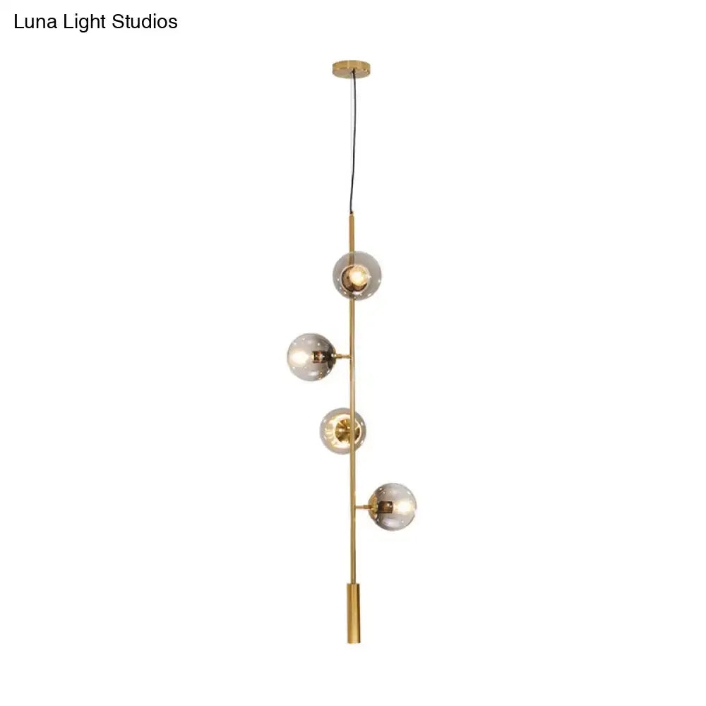 Modern gold linear chandelier with gray glass shades dining room