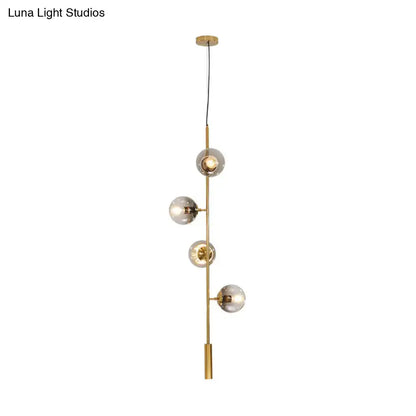 Modern gold linear chandelier with gray glass shades dining room