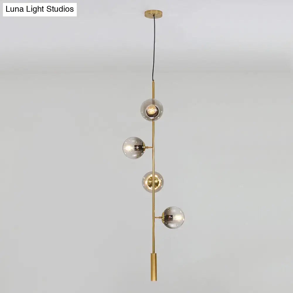 Modern gold linear chandelier with gray glass shades dining room