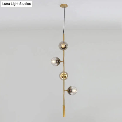 Modern gold linear chandelier with gray glass shades dining room