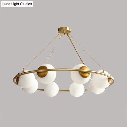 Modern brass ring chandelier with frosted glass spheres dining room