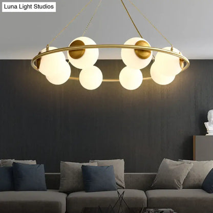 Modern brass ring chandelier with frosted glass spheres dining room