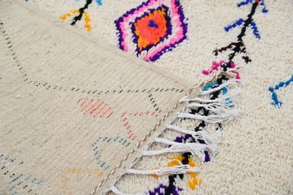 Handmade beige azilal rug with colorful patterns for bedroom
