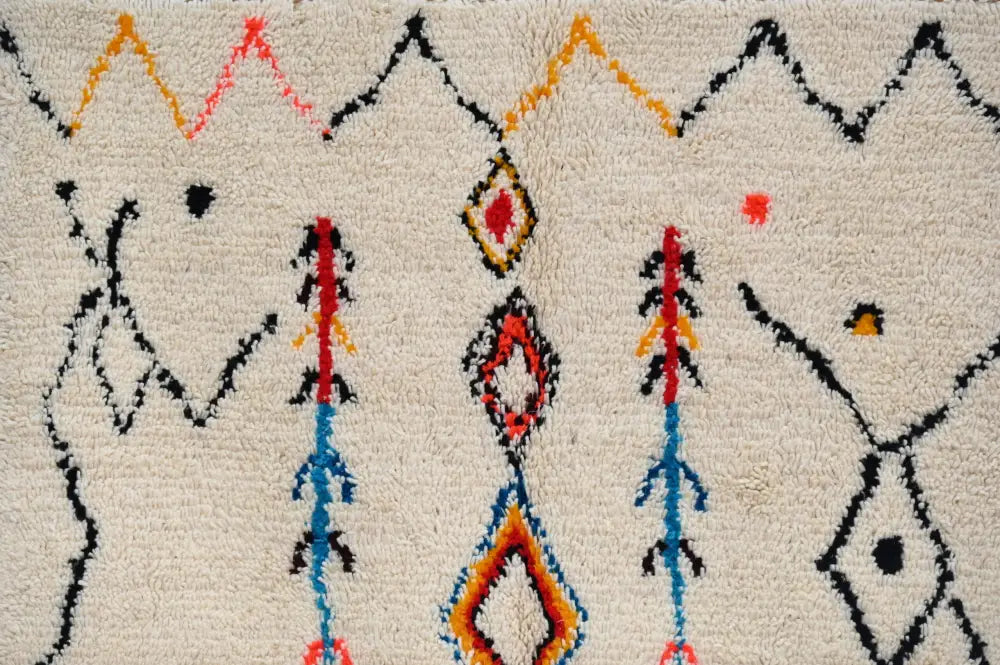 Handmade beige azilal rug with colorful patterns for bedroom