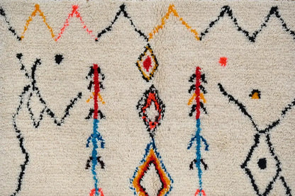Handmade beige azilal rug with colorful patterns for bedroom