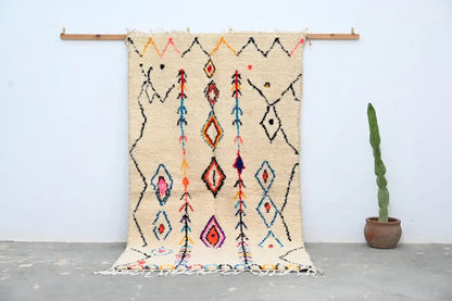 Handmade beige azilal rug with colorful patterns for bedroom