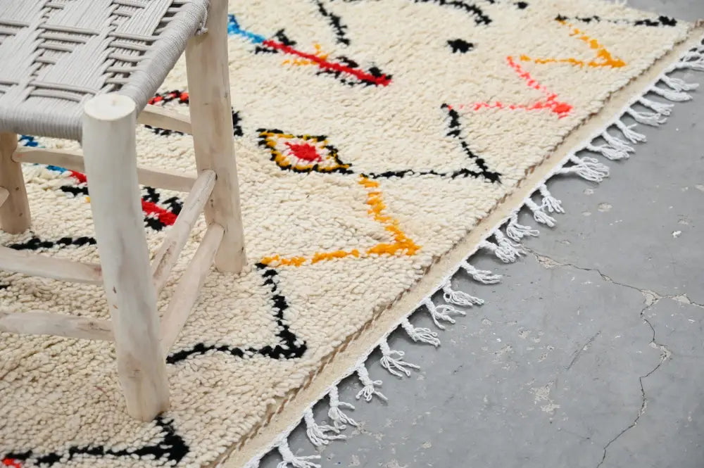 Handmade beige azilal rug with colorful patterns for bedroom