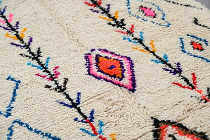 Handmade beige azilal rug with colorful patterns for bedroom