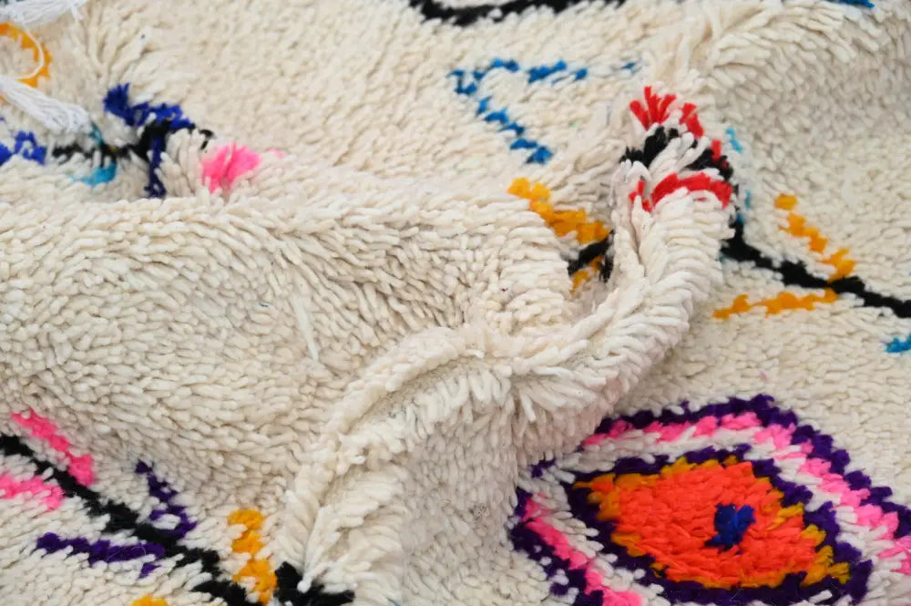 Handmade beige azilal rug with colorful patterns for bedroom