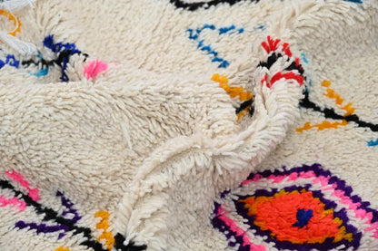 Handmade beige azilal rug with colorful patterns for bedroom