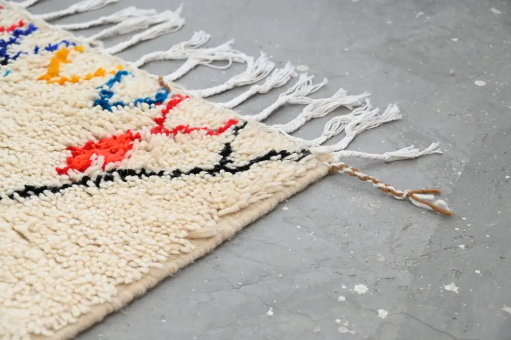 Handmade beige azilal rug with colorful patterns for bedroom
