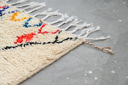 Handmade beige azilal rug with colorful patterns for bedroom