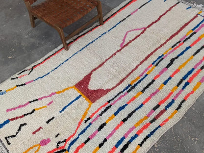 Moroccan handmade beige wool rug with colorful stripes living room