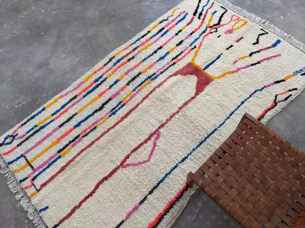Moroccan handmade beige wool rug with colorful stripes living room