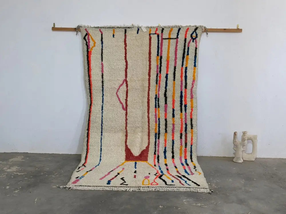 Moroccan handmade beige wool rug with colorful stripes living room