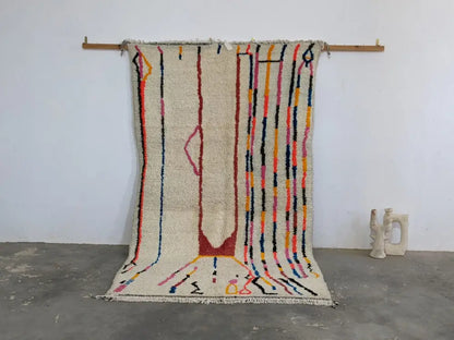 Moroccan handmade beige wool rug with colorful stripes living room