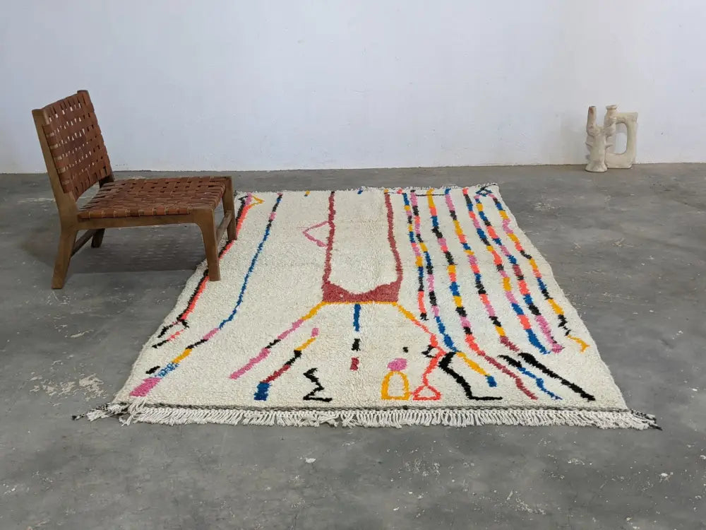 Moroccan handmade beige wool rug with colorful stripes living room
