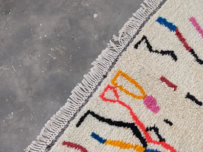 Moroccan handmade beige wool rug with colorful stripes living room