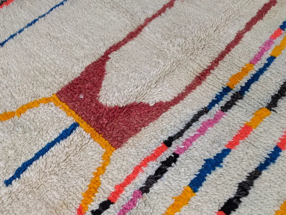 Moroccan handmade beige wool rug with colorful stripes living room