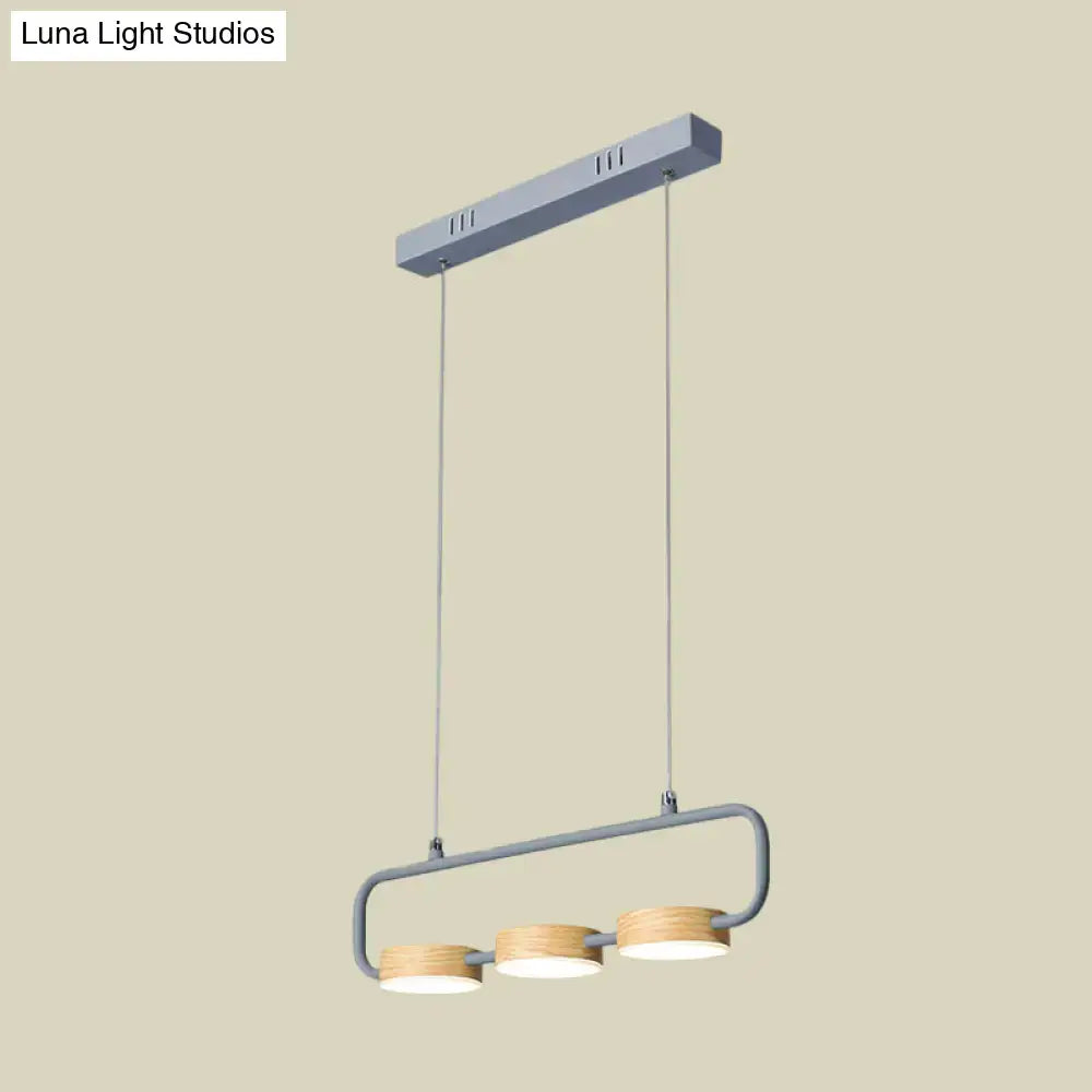 Modern mint green hanging pendant with wood accents for kitchen island