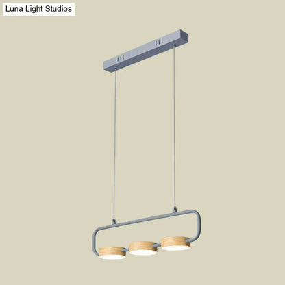Modern mint green hanging pendant with wood accents for kitchen island