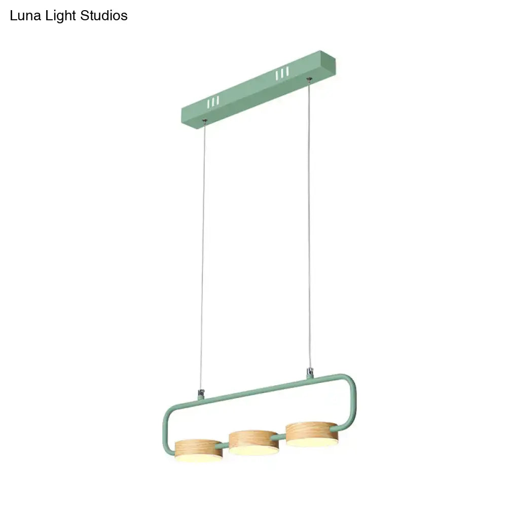 Modern mint green hanging pendant with wood accents for kitchen island