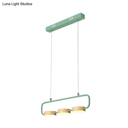 Modern mint green hanging pendant with wood accents for kitchen island