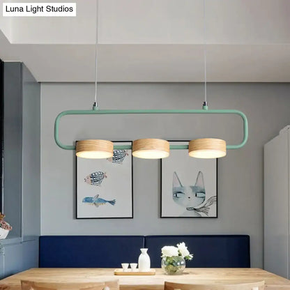 Modern mint green hanging pendant with wood accents for kitchen island