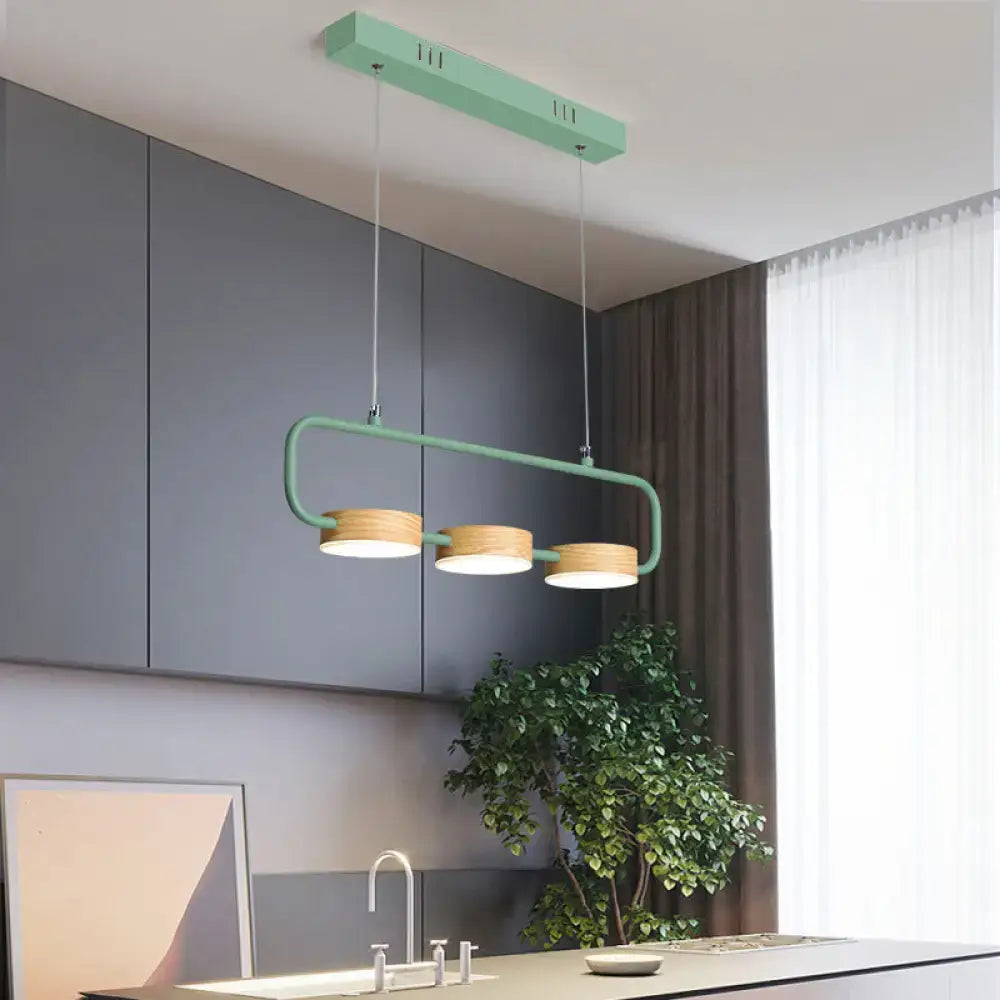 Modern mint green hanging pendant with wood accents for kitchen island
