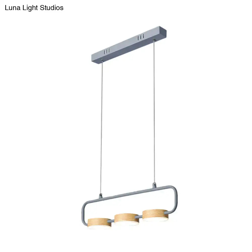 Modern mint green hanging pendant with wood accents for kitchen island