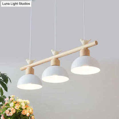 Minimalist wood and white bird hanging island light dining room