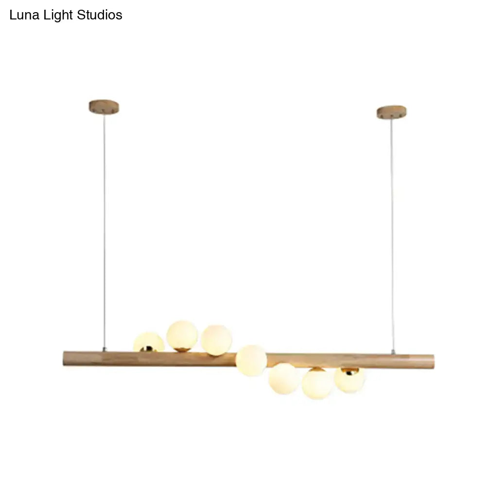 Minimalist beige wood island pendant with globe lights dining room