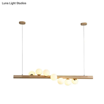 Minimalist beige wood island pendant with globe lights dining room